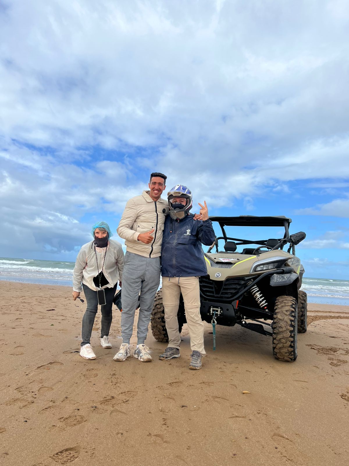 Happy group posing with buggy on Atlantic beach