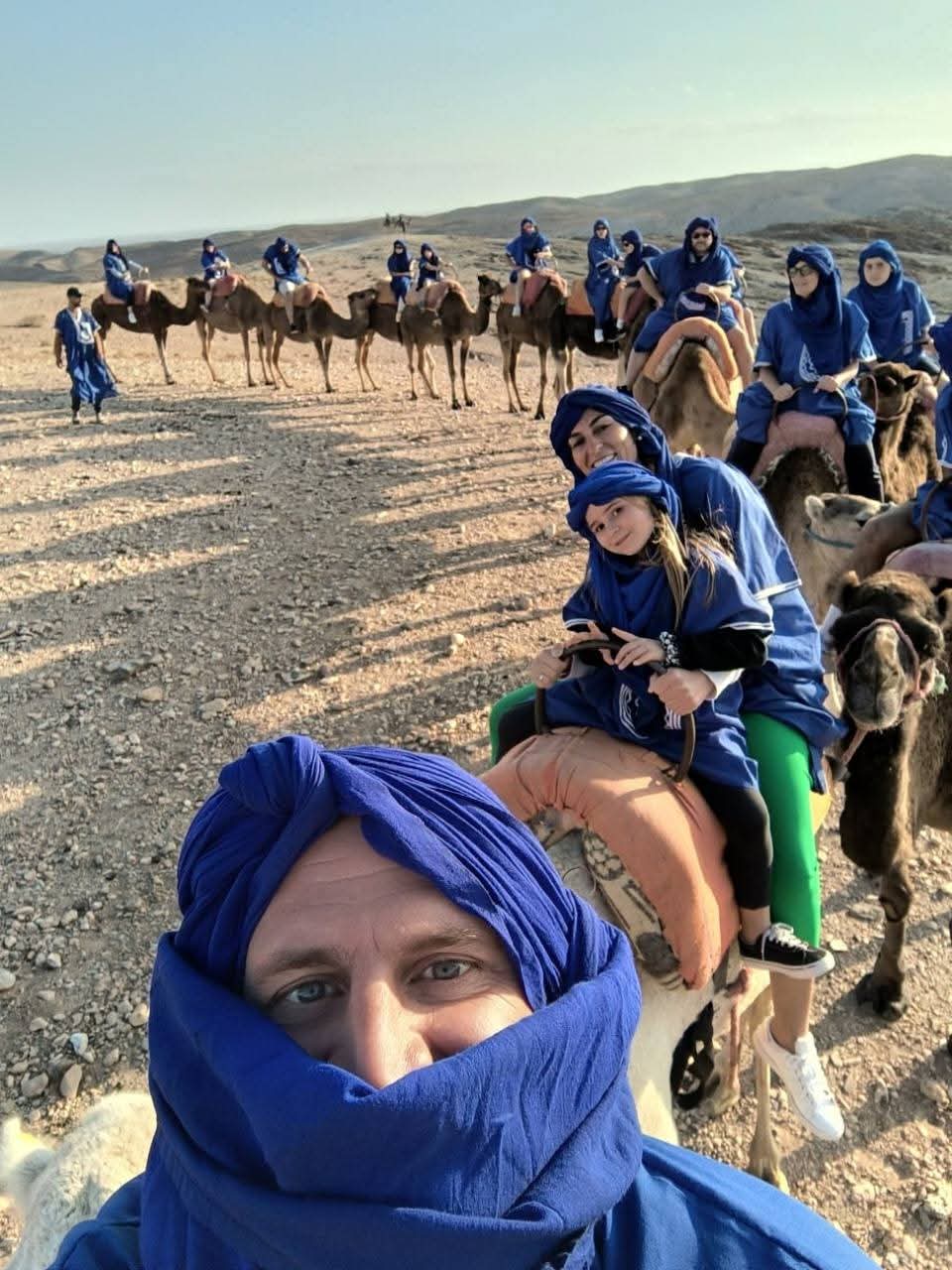 Large group on camel trek in desert