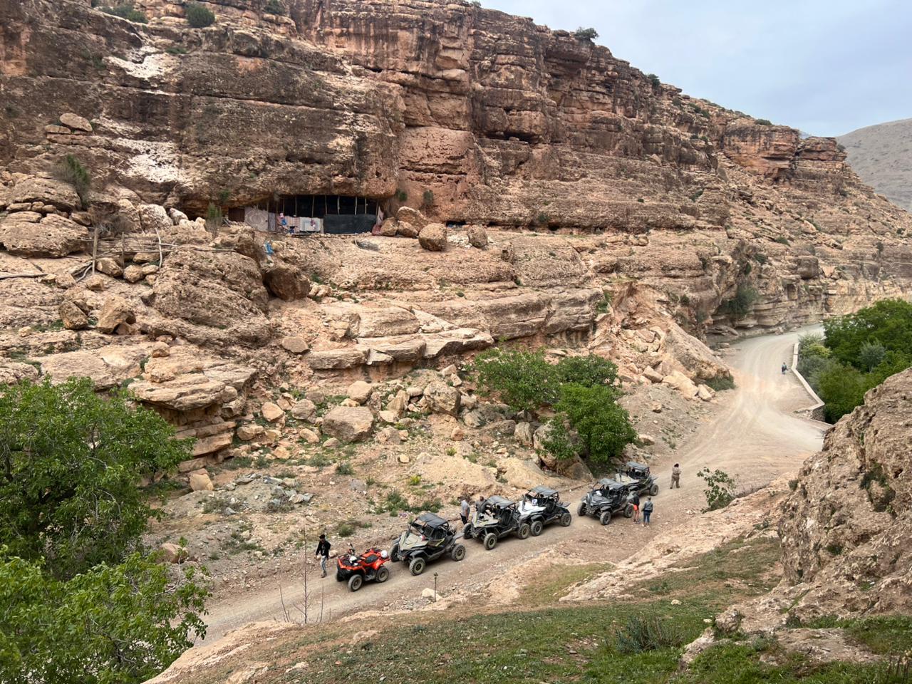 ATVs parked in dramatic rocky canyon landscape