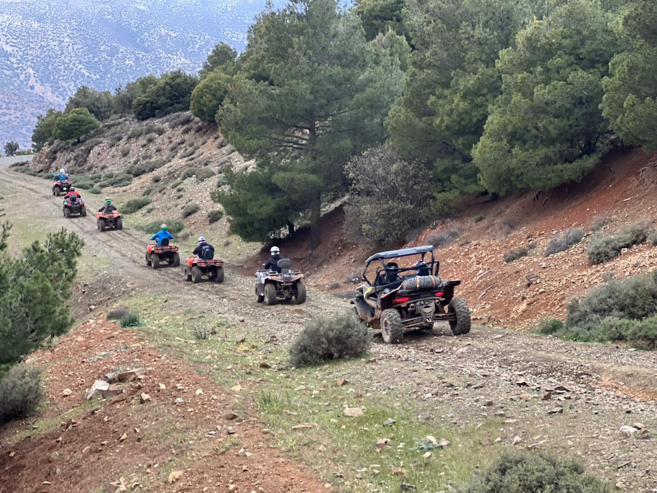 Group of ATVs and buggies on mountain trails