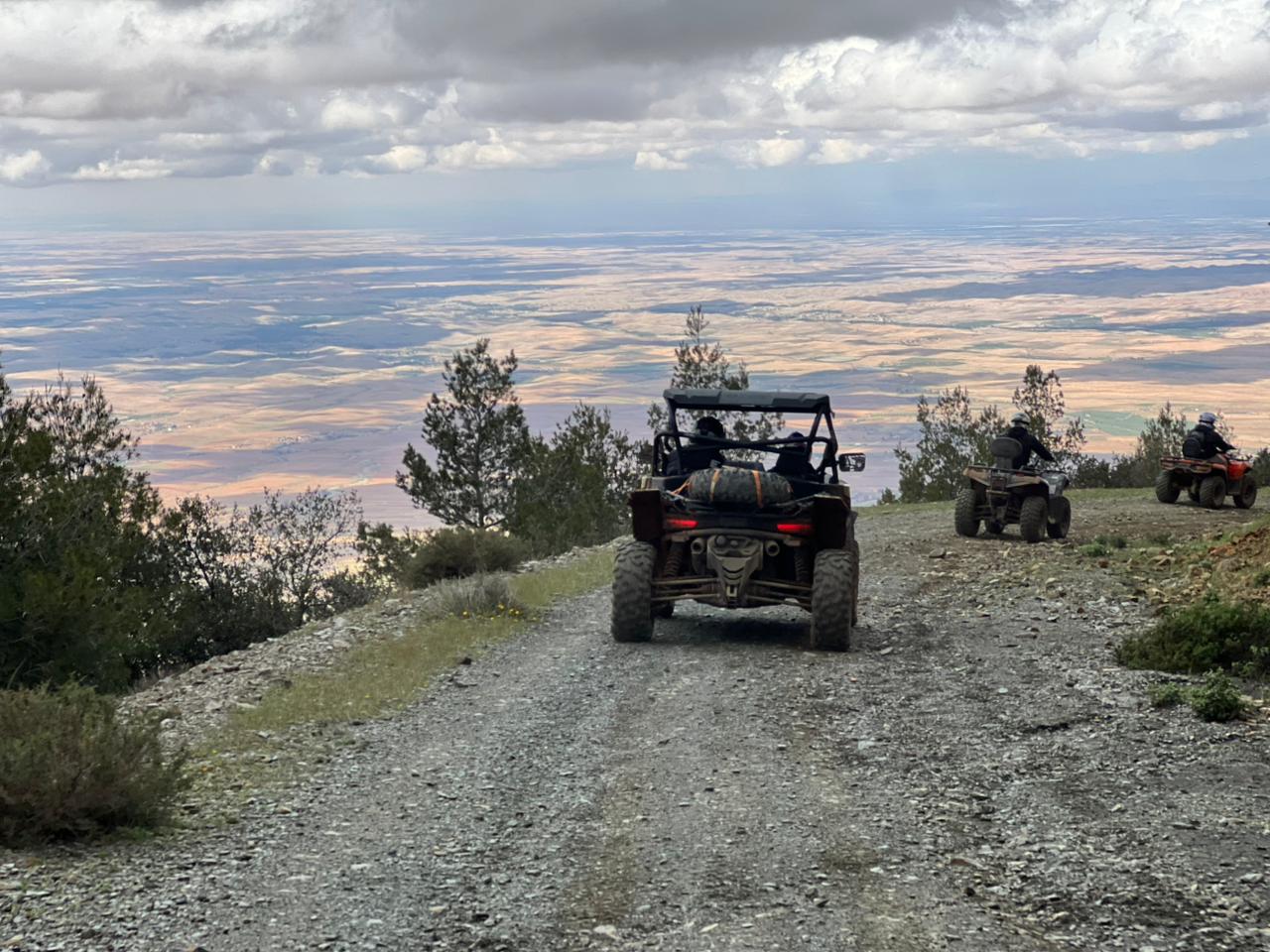 Buggies on mountain trail overlooking vast plains