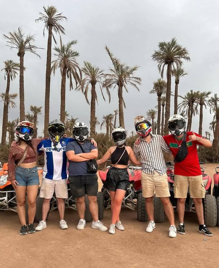 Group of people with helmets and ATVs among palm trees