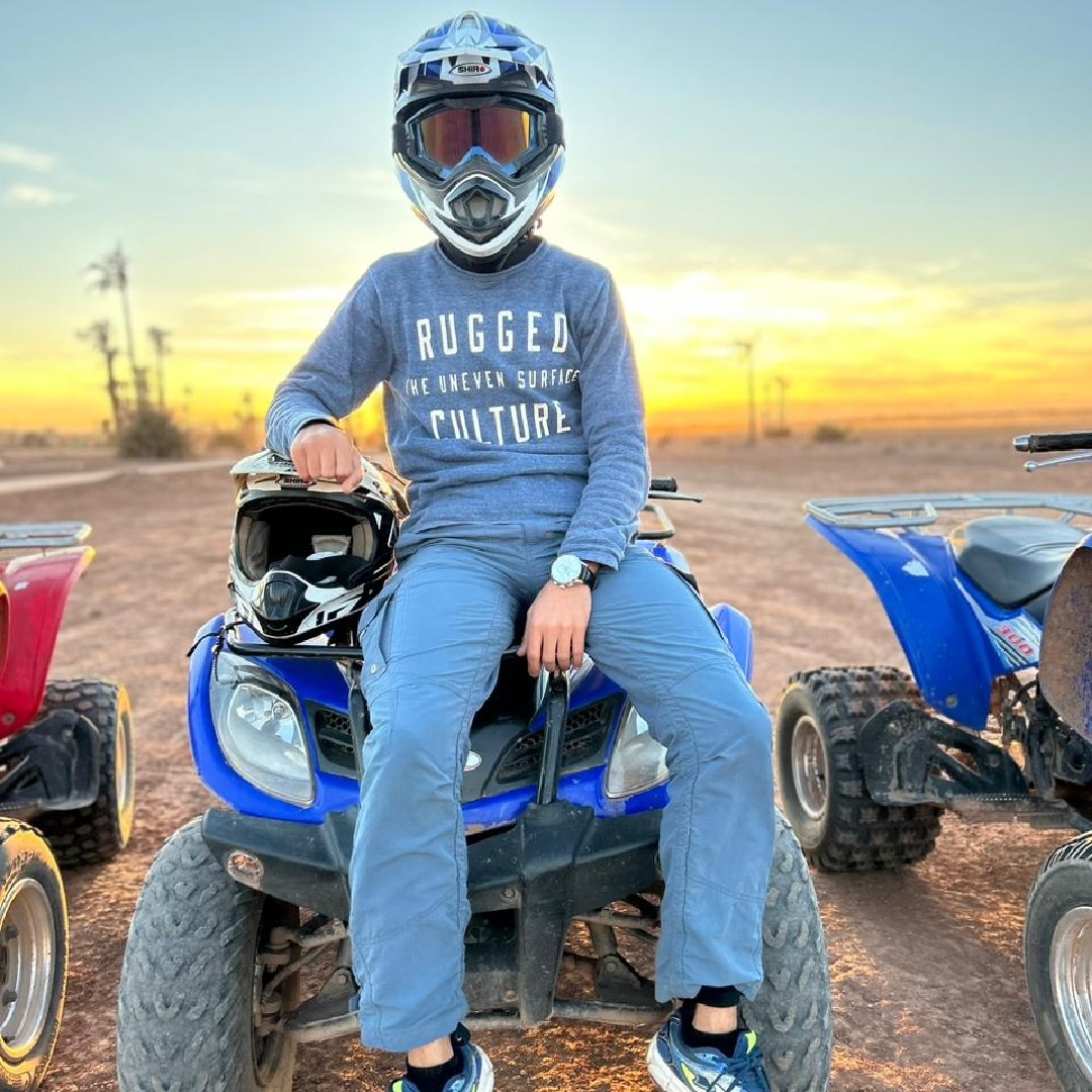 Quad rider at desert sunset