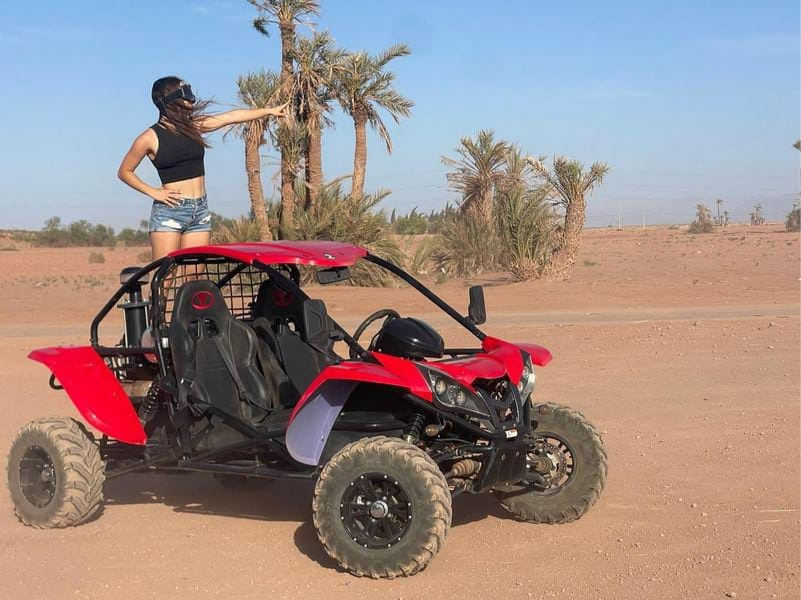 Woman with red buggy in palm oasis