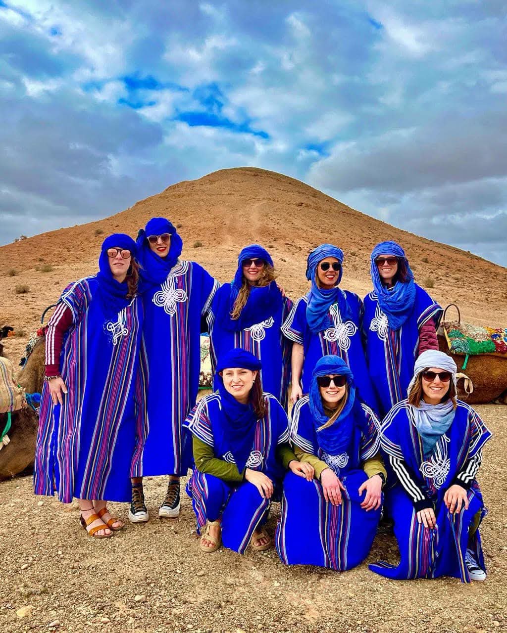 Group of women in traditional blue Berber robes in desert