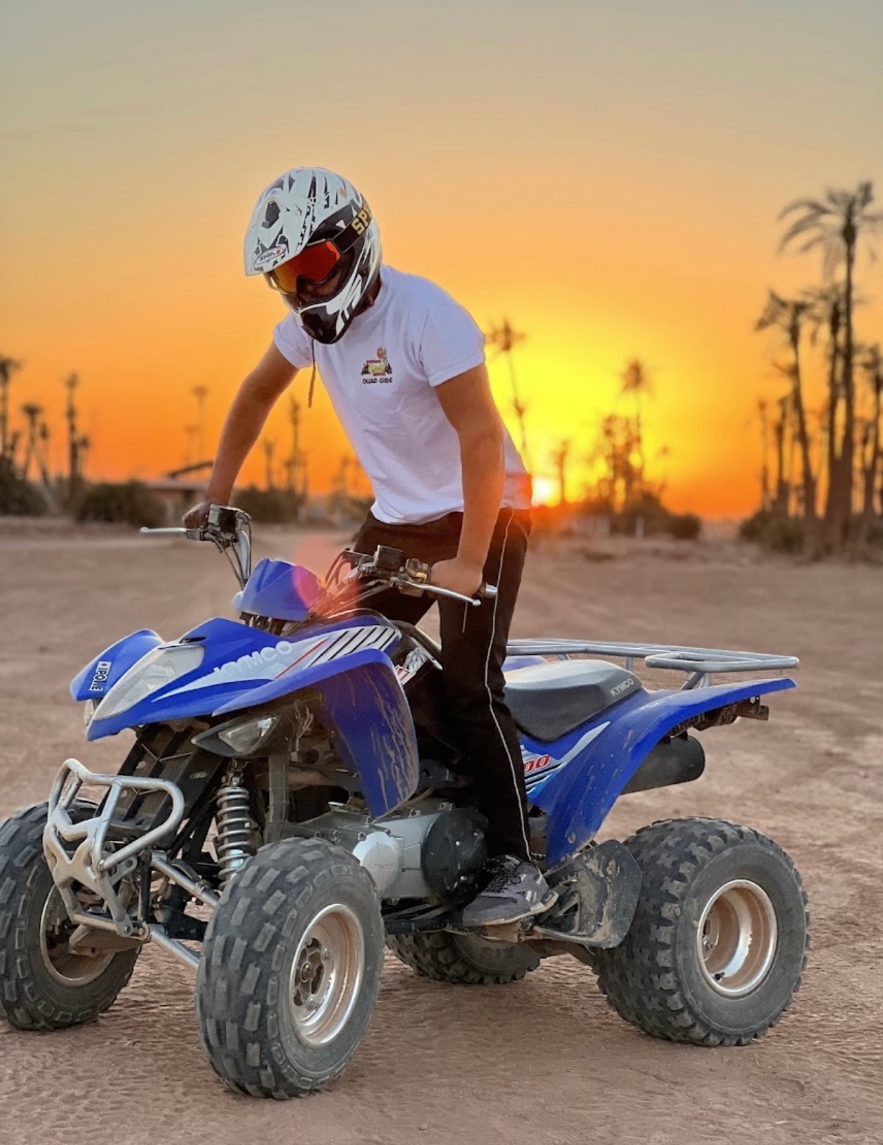 Quad biking at sunset in desert landscape